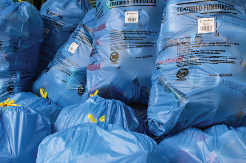 Close up image of a larges stack of Blue Bags from a BottleDrop Give fundraiser's event of the nonprofit's supporters dropping off bags.