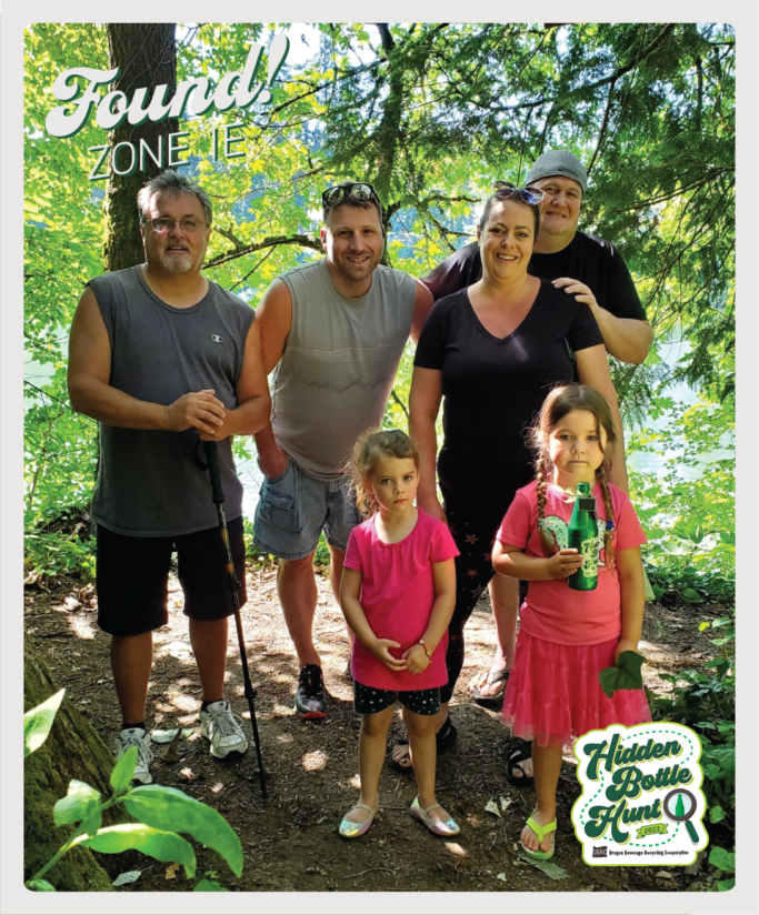 Photo of four adults and 2 kids who found the shiny green commemorative bottle.