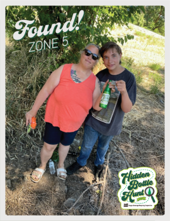 Photo of mom and child who found the shiny green commemorative bottle.