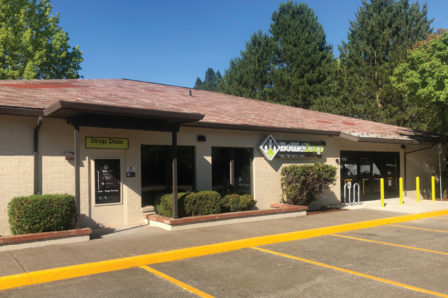 Photo of the exterior of the Corvallis Redemption Center on a bright, spring afternoon.