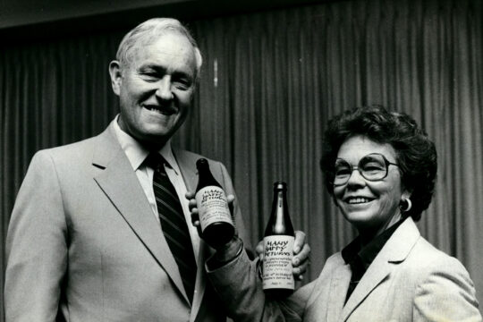 Black and white photo of Oregon Governor Tom McCall and Mary Roberts celebrating the state bottle bill's tenth anniversary.