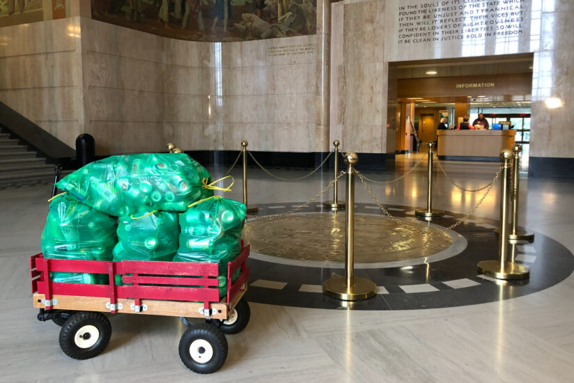 Filled BottleDrop Green Bags in a Radio Flyer wagon sit in the Oregon capitol